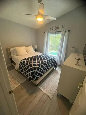 a bedroom with a bed and a window at Family Dream Home Near Disney in Kissimmee