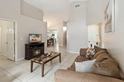 a living room with a couch and a fireplace at Cozy Home Near Disney!!! in Kissimmee