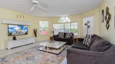 a living room with two couches and a tv at Villas At Island Club Community, Pools, Jacuzzi And More! in Kissimmee