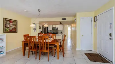 a dining room and kitchen with a table and chairs at Villas At Island Club Community, Pools, Jacuzzi And More! in Kissimmee