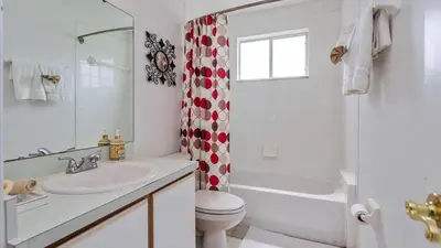 a bathroom with a sink and a toilet and a shower at Villas At Island Club Community, Pools, Jacuzzi And More! in Kissimmee