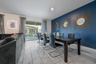 a dining room with a table and chairs and a couch at Storey Lake Resort 1136 - Hosted by Top Villas in Kissimmee