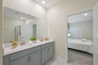 a bathroom with a sink and a mirror and a bed at Storey Lake Resort 1136 - Hosted by Top Villas in Kissimmee