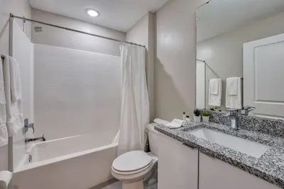 a white bathroom with a tub and a toilet and a sink at Formosa Valley Resort 60 - Hosted by Top Villas in Orlando