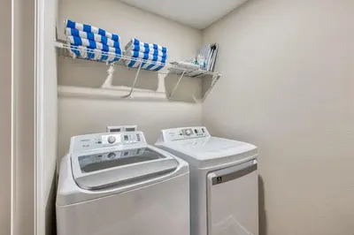 a small laundry room with a washer and dryer at Formosa Valley Resort 60 - Hosted by Top Villas in Orlando