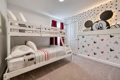 a childs bedroom with a bunk bed with mickey mouse wallpaper at Formosa Valley Resort 62 - Hosted by Top Villas in Orlando