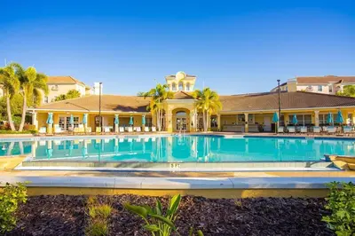 a large swimming pool in front of a house at Last Minute Disney Getaway Luxury Condo with Private Balcony. Book Now VC240 in Orlando