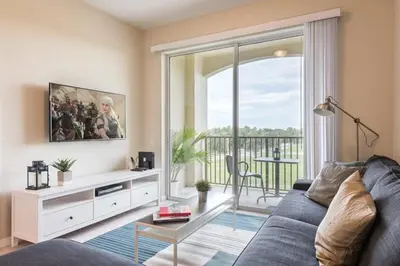 a living room with a couch and a large window at Last Minute Disney Getaway Luxury Condo with Private Balcony. Book Now VC240 in Orlando