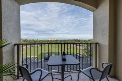 a patio with a table and chairs on a balcony at Last Minute Disney Getaway Luxury Condo with Private Balcony. Book Now VC240 in Orlando