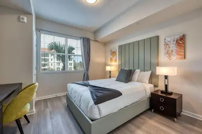 a bedroom with a bed and a desk and a window at Vista Cay 239 - Hosted by Top Villas in Orlando