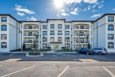 a large building with cars parked in a parking lot at Vista Cay 239 - Hosted by Top Villas in Orlando