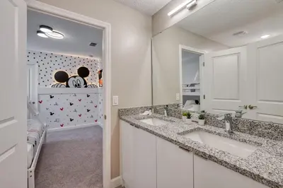 a bathroom with two sinks and a mirror at Formosa Valley Resort 63 - Hosted by Top Villas in Orlando