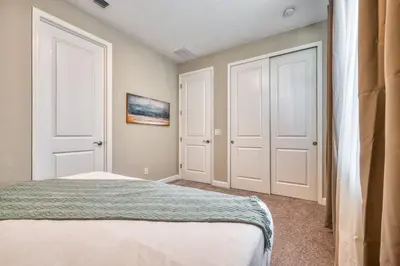 a bedroom with two white doors and a bed at Formosa Valley Resort 64 - Hosted by Top Villas in Orlando