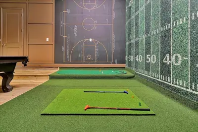 a room with a ping pong table and a green rug at Epic Orlando Mansion-Pool-Game Room-Theater-2 in Orlando