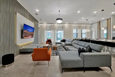 a living room with couches and a dining room at Epic Orlando Mansion-Pool-Game Room-Theater-2 in Orlando