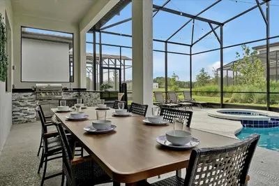 a wooden table with chairs and a tableasteryasteryasteryasteryasteryasteryasteryastery at Epic Orlando Mansion-Pool-Game Room-Theater-2 in Orlando