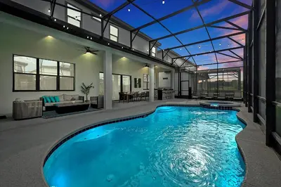 a swimming pool in a house with a glass ceiling at Epic Orlando Mansion-Pool-Game Room-Theater-2 in Orlando