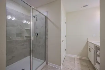 a bathroom with a shower with a glass door at Storey Lake Resort 1059 - Hosted by Top Villas in Kissimmee