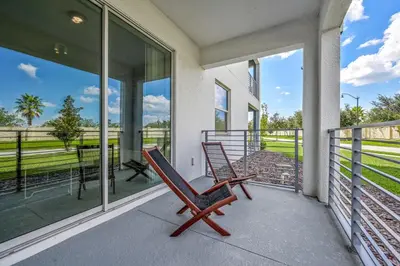 a rocking chair on the balcony of a house at Storey Lake Resort 1059 - Hosted by Top Villas in Kissimmee