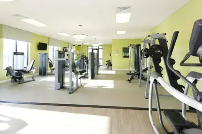 a gym with treadmills and elliptical machines at Beautiful 5bed home with Free Resort Access 4817 in Kissimmee