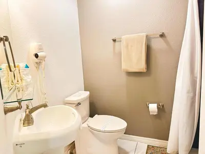 a bathroom with a white toilet and a sink at LB4701PL - 4 Beds villa - with pool and game room in Kissimmee