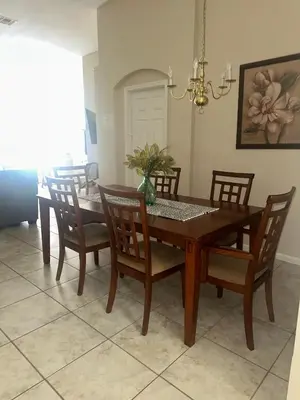 a dining room table and chairs in a room at Magical Home with private pool and close to parks in Kissimmee