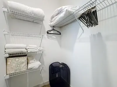 a laundry room with white walls and white towels at Luxury Apartments Near Disney in Orlando