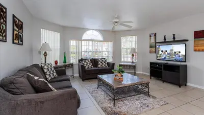 a living room with two couches and a tv at Villas At Island Club Community, Pools, Jacuzzi And More! in Kissimmee