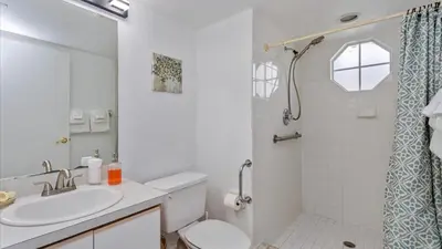 a bathroom with a sink and a toilet and a shower at Villas At Island Club Community, Pools, Jacuzzi And More! in Kissimmee
