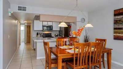 a dining room and kitchen with a table and chairs at Villas At Island Club Community, Pools, Jacuzzi And More! in Kissimmee