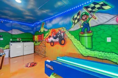 a childs room with a mural of a race car at Free Arcade! All Rooms Themed! South Facing Pool! in Orlando