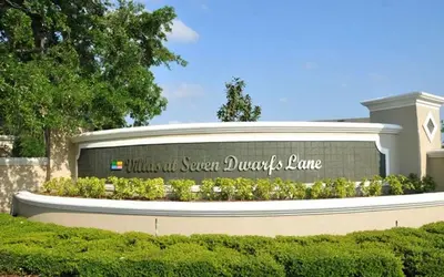 a sign in front of a building with a sign at 4 Bedroom 3 Bathroom Villas At SevenDwarfs 27-108 in Kissimmee