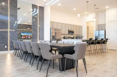 a dining room with a long table and chairs at BRAND NEW 15Bed Home wprivate Pool 5824 in Orlando