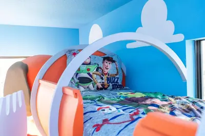 a childs bedroom with a bed with a cartoon on it at BRAND NEW 15Bed Home wprivate Pool 5824 in Orlando