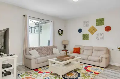 a living room with a couch and a table at Waterpark Disney wPoolLakeView Storey Lake in Kissimmee