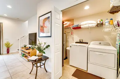 a laundry room with a washer and dryer at 4 Mi to Disney World Townhome with Hot Tub and Lanai! in Kissimmee