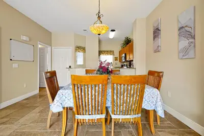 a kitchen and dining room with a table and chairs at Lakefront Villa in Terra Verde:Pool & Resort Amenities in Kissimmee