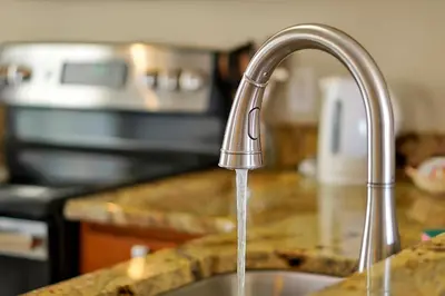 a kitchen sink with water coming from a faucet at Lakefront Villa in Terra Verde:Pool & Resort Amenities in Kissimmee