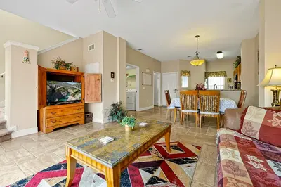 a living room with a couch and a tv at Lakefront Villa in Terra Verde:Pool & Resort Amenities in Kissimmee