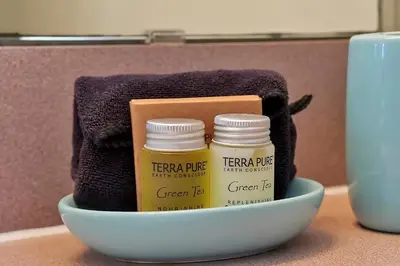 a bowl with two jars of green tea and a towel at Lakefront Villa in Terra Verde:Pool & Resort Amenities in Kissimmee