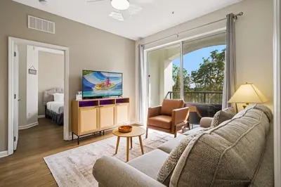 a living room with a couch and a tv and a bed at 4024 Breakview Drive 303 in Orlando