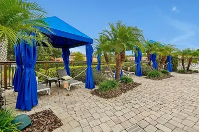 a group of blue umbrellas and palm trees at Corvette Getaway - 2 beds - jacuzzi - Forest view in Orlando