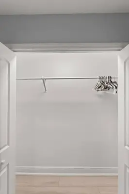 a room with white walls and white floors and shoes at Luxury Ranch Master King Bed with heated Salted Pool in Orlando