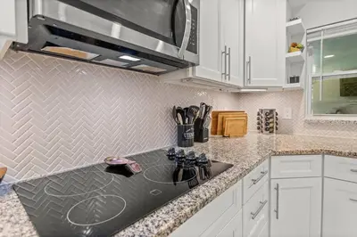 a kitchen with a sink and a counter top at Luxury Ranch Master King Bed with heated Salted Pool in Orlando