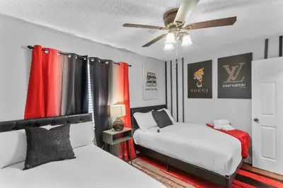 a bedroom with two beds and a ceiling fan at King bd Charming 2-Storey Cottage w PrivateYard in Orlando