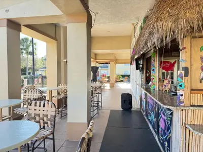a restaurant with tables and chairs and a bar at 4 Bedroom 3 Bathroom Villas At SevenDwarfs 17-101 in Kissimmee