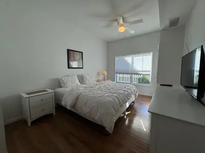 a bedroom with a bed and a flat screen tv at 3 Bedroom 2 Bathroom Villas At SevenDwarfs 8-103 in Kissimmee