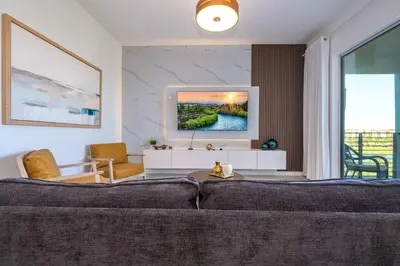 a living room with a couch and a large window at 3191#402 Family Fun 3BR Themed Apt Near Disney in Kissimmee