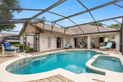 a large swimming pool with a glass roof at Beautiful 4 Bed Villa With Southwest Facing Pool in Orlando
