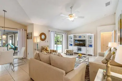 a living room with a couch and a table at Beautiful 4 Bed Villa With Southwest Facing Pool in Orlando